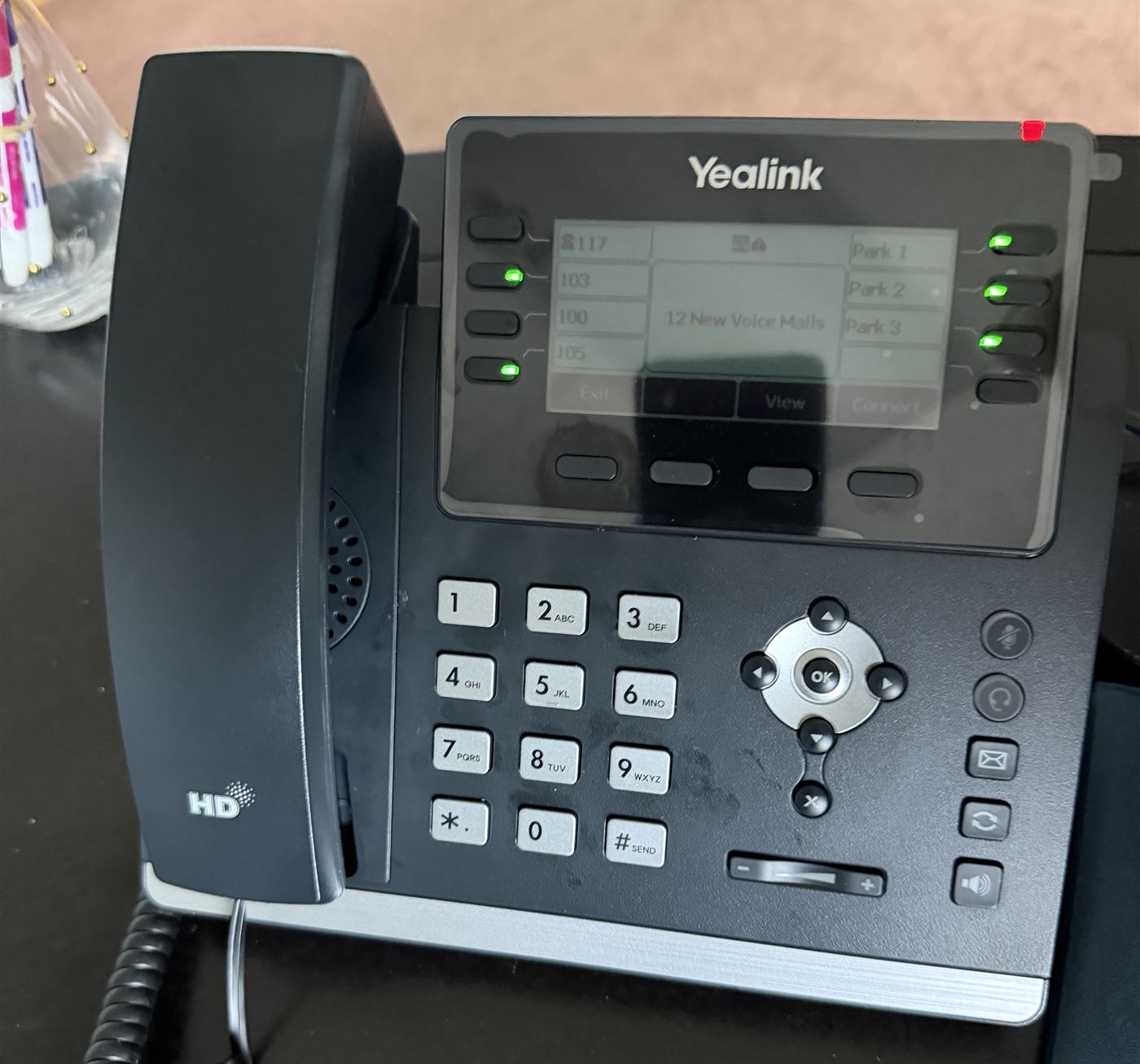 A Yealink phone with extension and call park keys at a client office